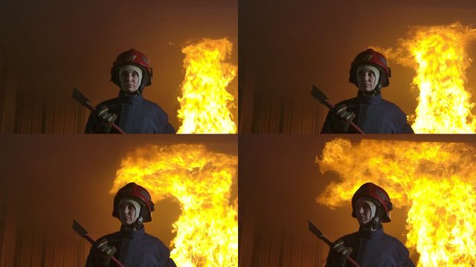 慢动作消防员站在镜头前，背景是火。