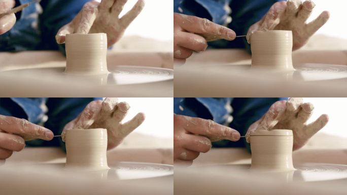 一个人的手在陶轮上模塑湿粘土。男性陶工在他的工作室里雕刻陶瓷艺术。特写一位手工艺师制作手工工艺品作为