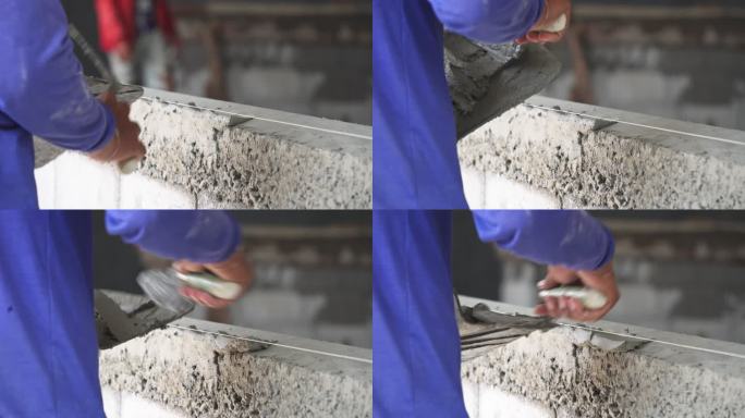 建筑工人正在给墙壁抹灰