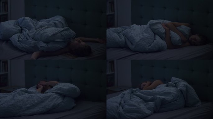 睡在床上的女人因失眠而无法入睡