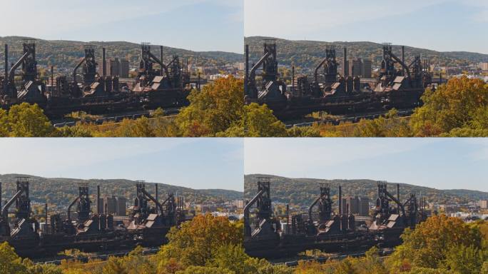 SteelStacks-宾夕法尼亚州伯利恒的历史性钢铁计划。无人机拍摄的树木后摇摄的空中视频。