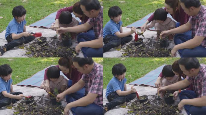 一位父亲和一位母亲教他们的两个儿子如何利用厨房和花园垃圾制造有机肥料