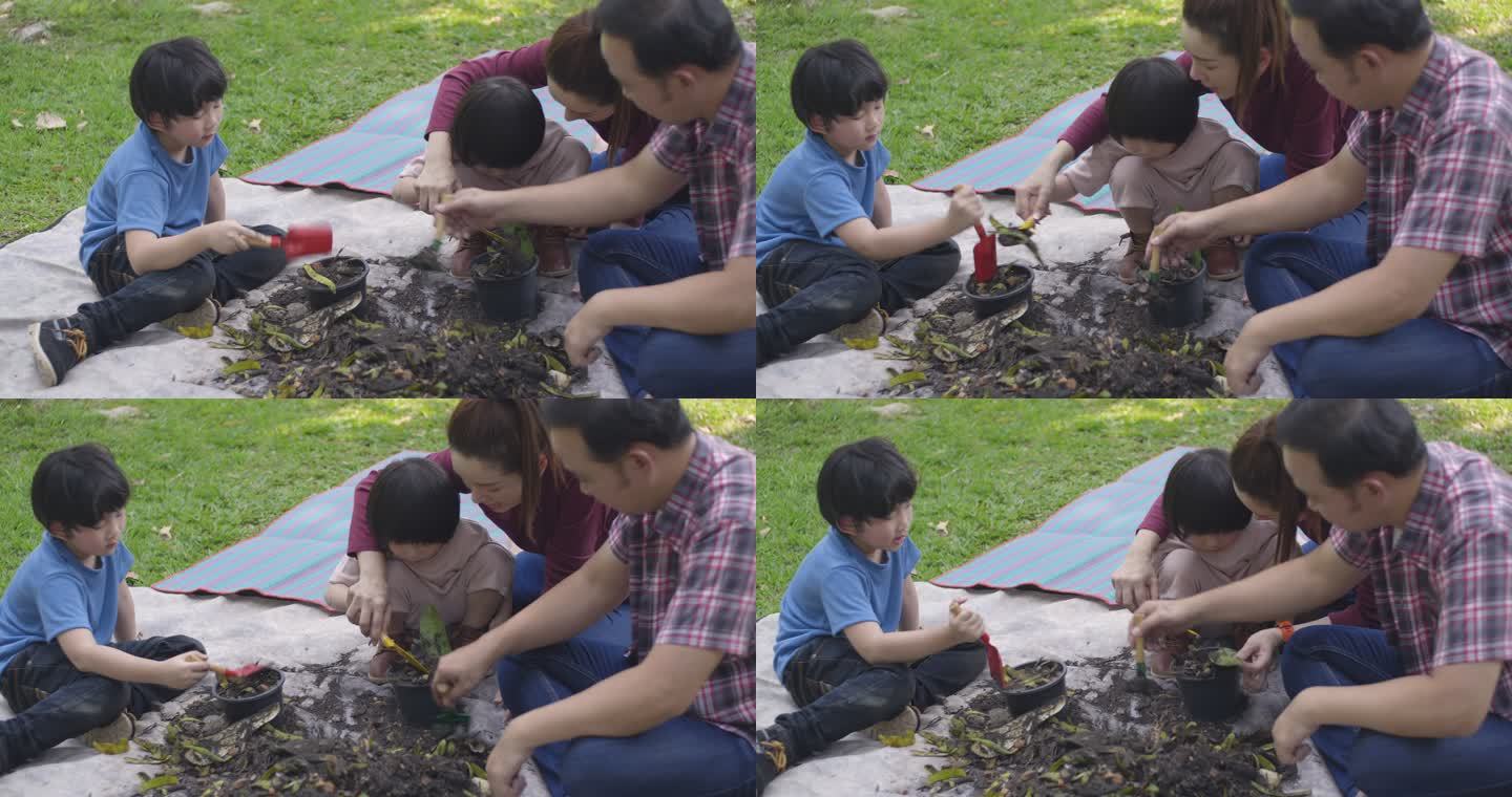 一位父亲和一位母亲教他们的两个儿子如何利用厨房和花园垃圾制造有机肥料