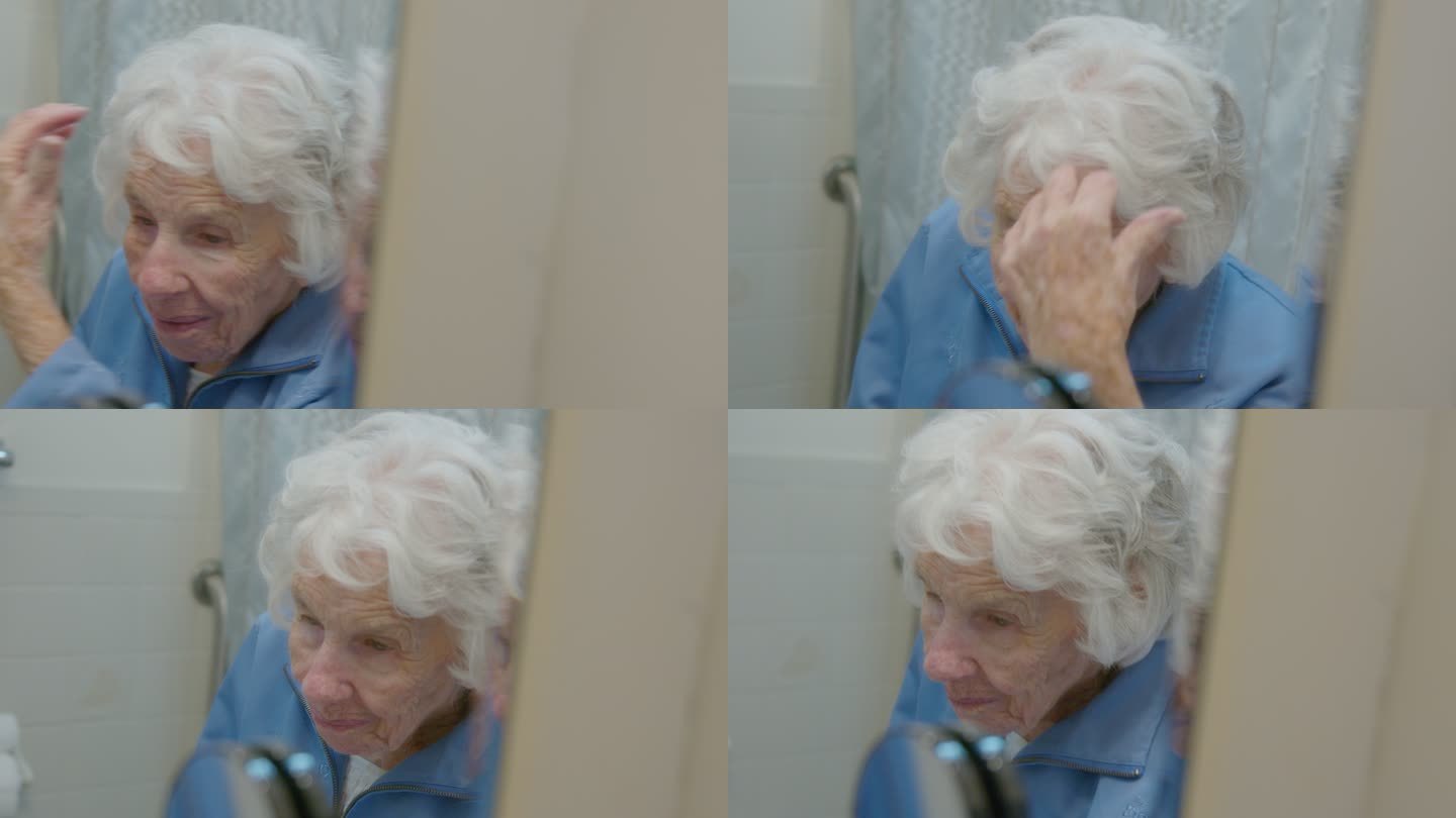 一位100岁的老妇人在镜子里梳头