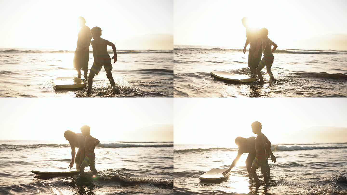快乐的男孩和爸爸在海滩上冲浪