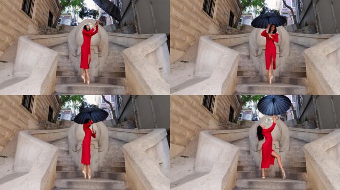 美丽的芭蕾舞演员在古老的石头楼梯上打着伞跳舞。伊斯坦布尔的卡蒙多楼梯