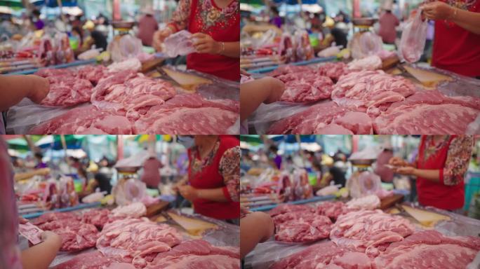 泰国的亚洲生鲜市场，他们正在购买猪肉。