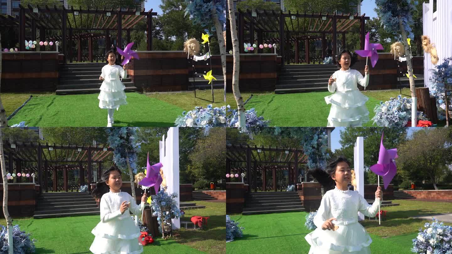 草坪婚礼唯美镜头--拿风车奔跑的小女孩