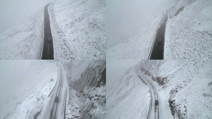 航拍下雪天行驶在山路上的汽车