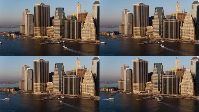 从东河鸟瞰曼哈顿市中心，水上的士和船只抵达和离开11号码头-华尔街。用静态摄像机拍摄无人机视频。