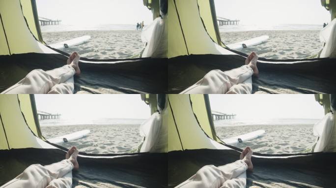 一个男人在海滩上的帐篷里放松