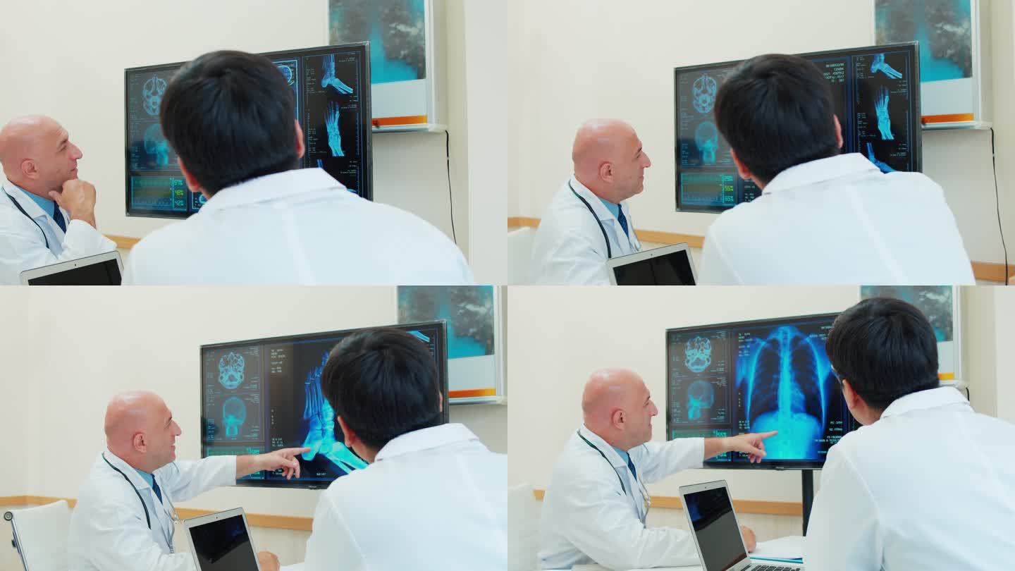 两名白人男性医生在监控电脑屏幕上分析和讨论的4k视频。他们正在医疗中心谈话。