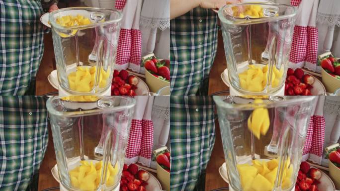 在搅拌机中混合芒果以制备棒状冰淇淋