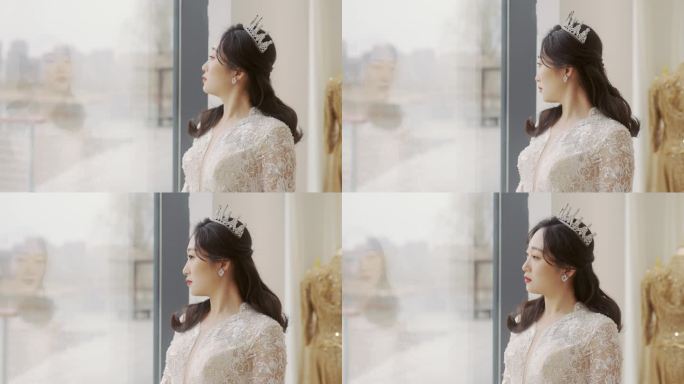 一位穿着婚纱的年轻女子站在落地窗前