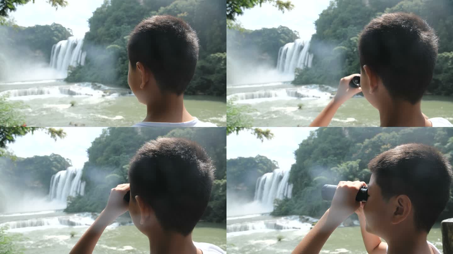 男孩用望远镜看瀑布