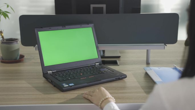 白领打开笔记本办公加班电脑绿布可转场