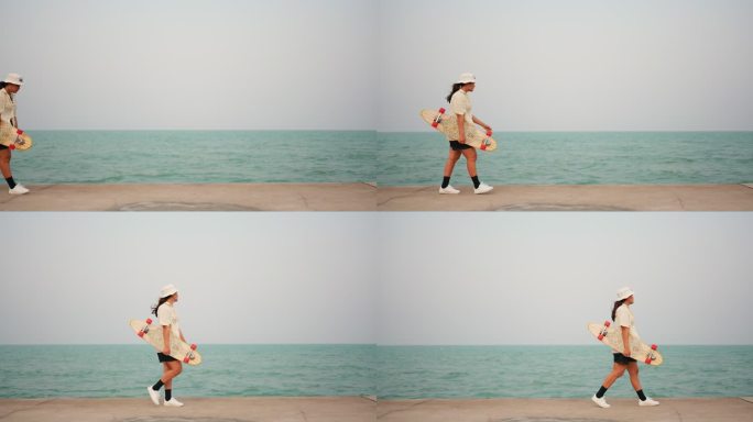 手拿滑板的女人在海边散步