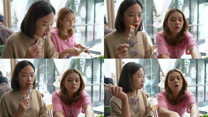 两名亚洲女性在当地融合美食餐厅吃午饭。