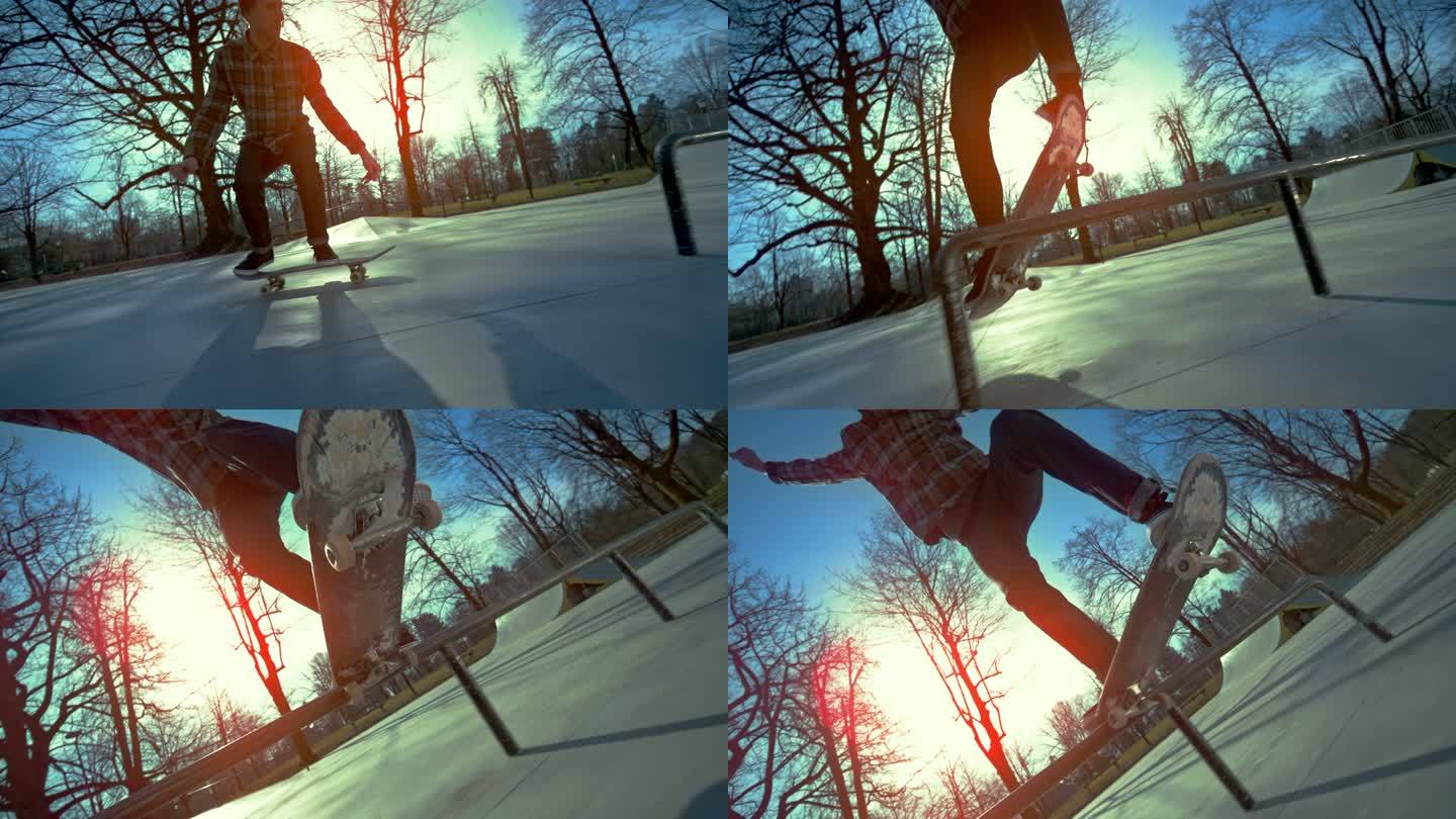 SLO MO TS男子滑板运动员在阳光明媚的公园里滑轨跳跃