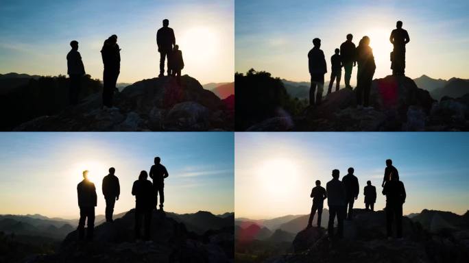 团队登山攀登顶峰一群人山顶逆光剪影看日落