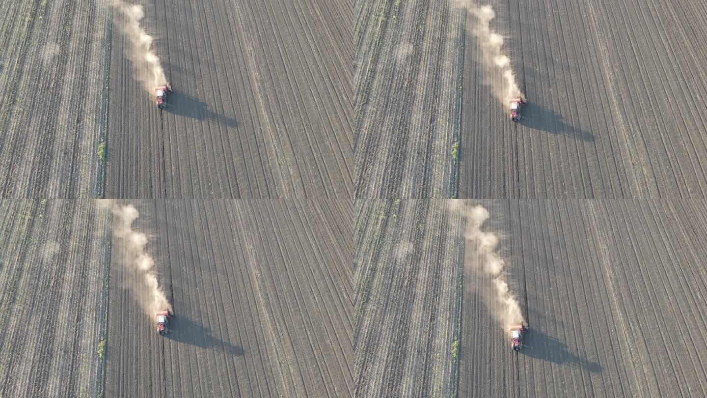拖拉机耕作多尘田地的鸟瞰图