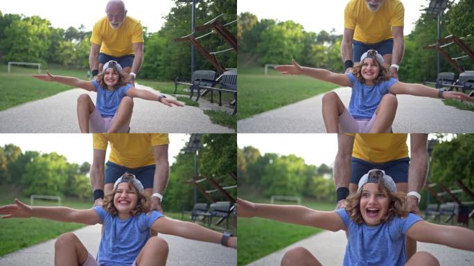 快乐的男孩，在爷爷推着他玩儿童滑板的时候，他和爷爷玩得很开心