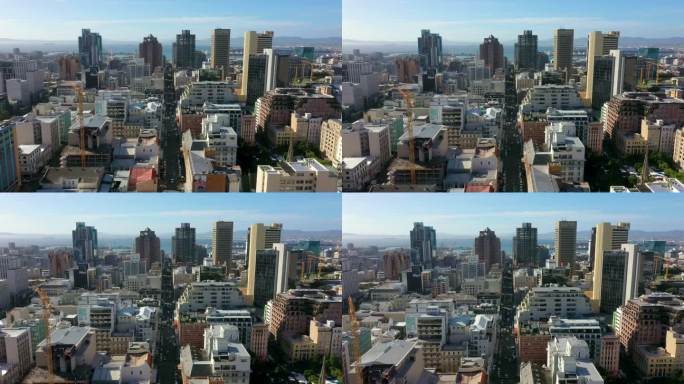 在晴朗的夏日，无人机鸟瞰城市景观。上图是白天繁忙的城市建筑和建筑。夏日的市区美景