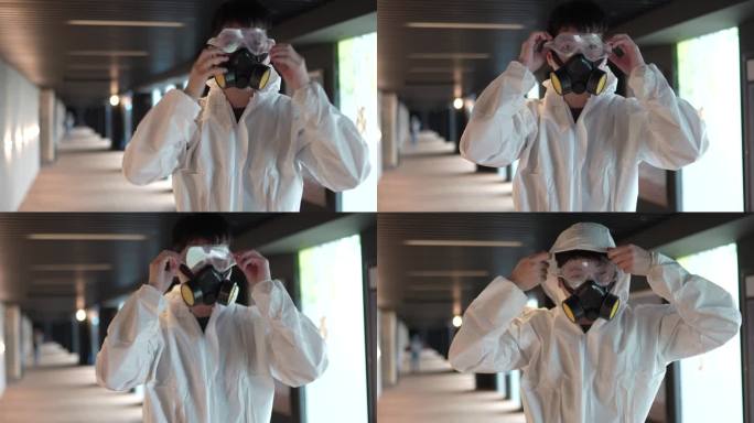 亚裔华人电影院卫生工作者戴着口罩准备在电影院走廊消毒