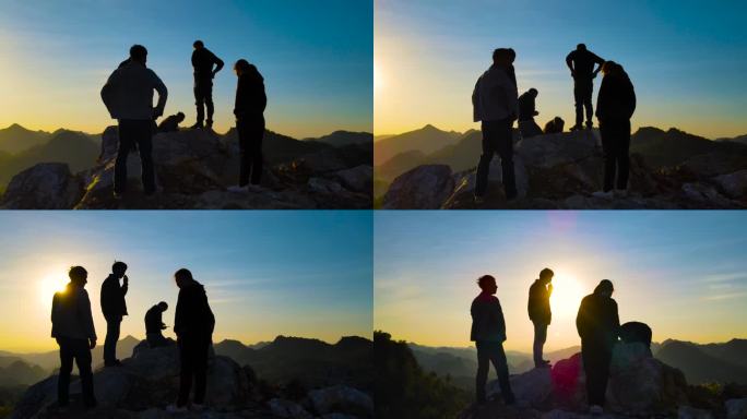 一群旅行者登山看日落山顶逆光剪影登上山顶