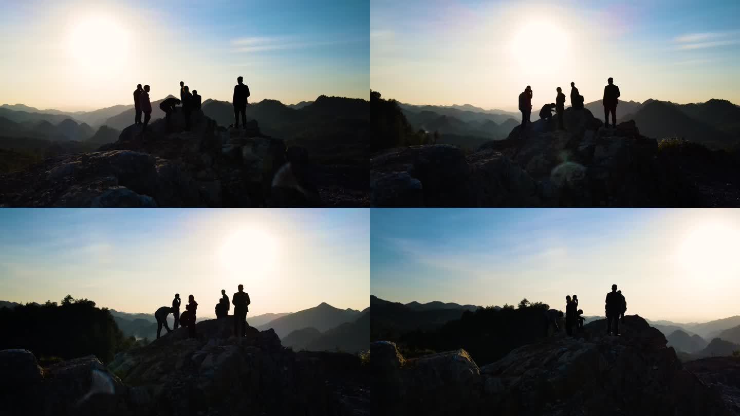 一群人山顶眺望观看日落成功登上山顶登山者