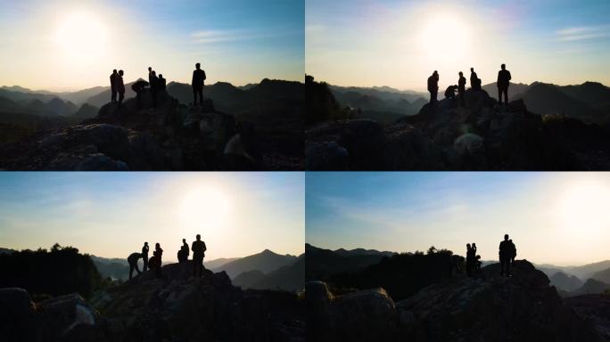 一群人山顶眺望观看日落成功登上山顶登山者