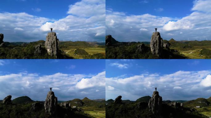 背包客登山在山顶张开双臂拥抱太阳眺望远方