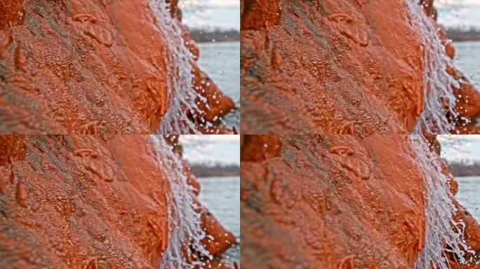 清澈的淡水流经岩石的特写镜头