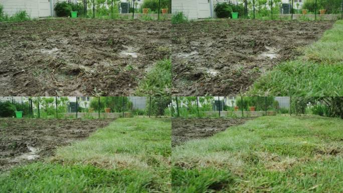 摄像机从一个泥泞的后院移动到一个住宅后院中新铺草皮的区域