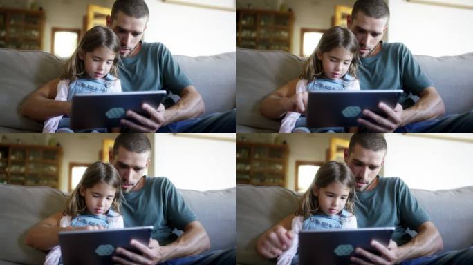 男子在家中向女儿展示数字平板电脑