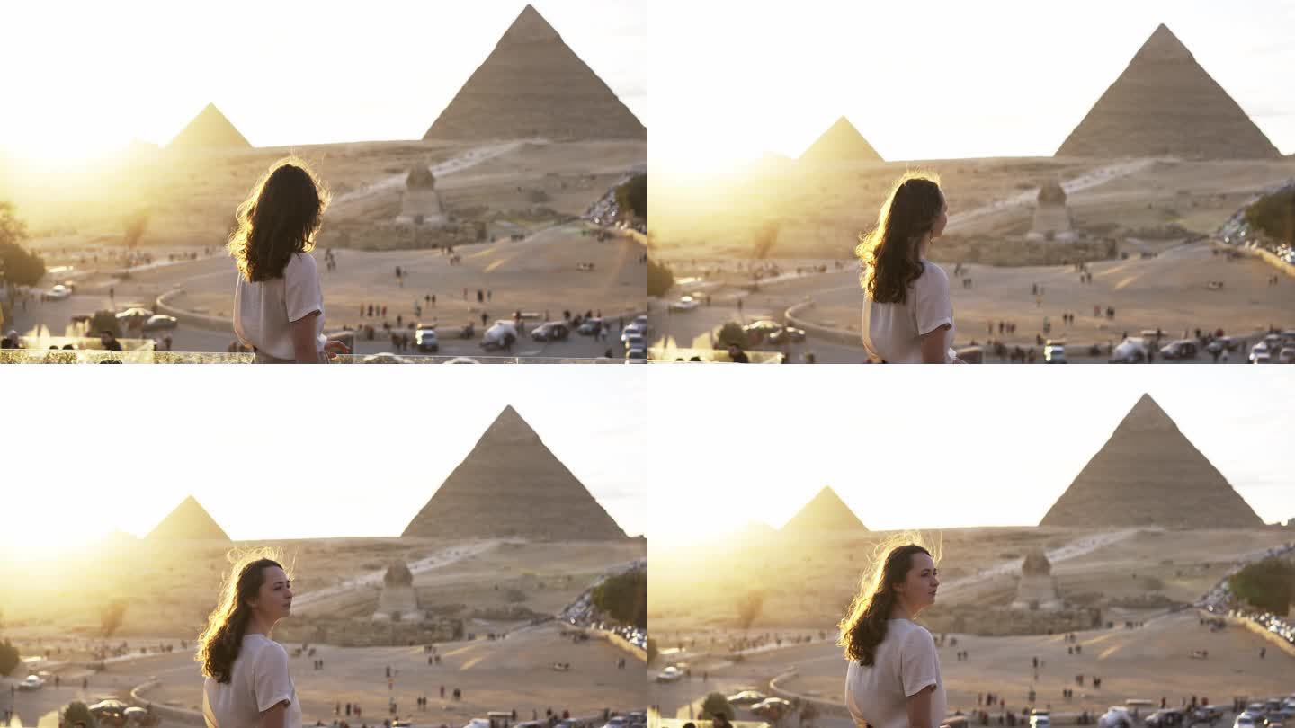站在吉萨金字塔背景的露台上的女人