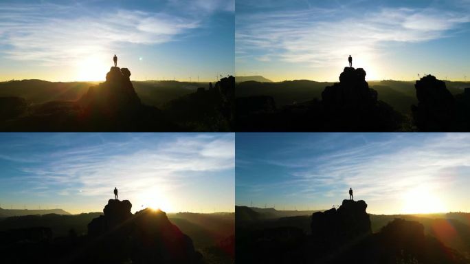 登山素材大气商务男士站在山顶眺望日出曙光