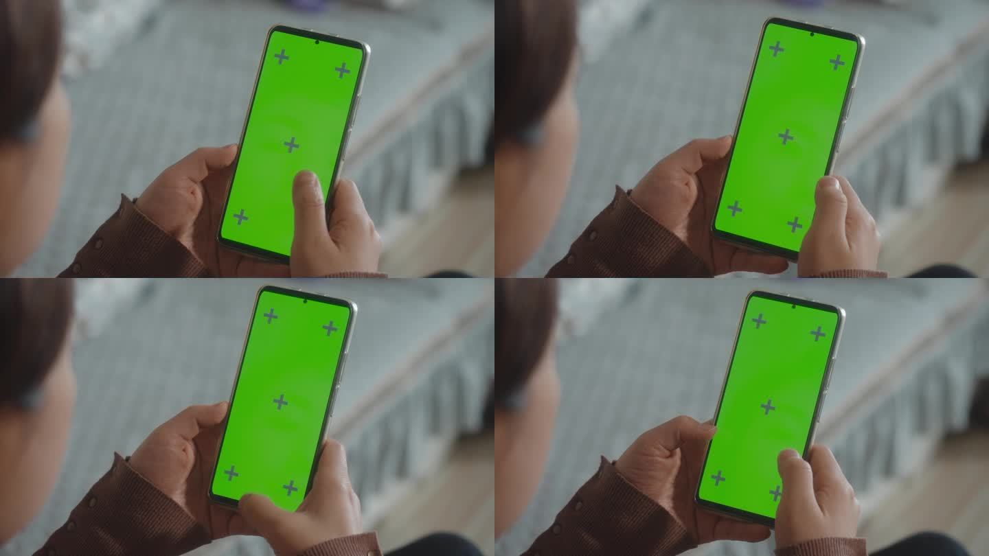 使用绿色屏幕智能手机的女性