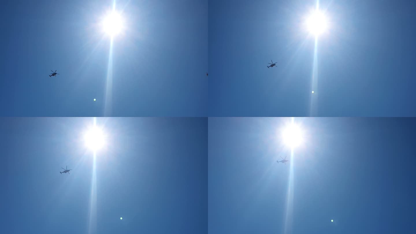 直升飞机掠过太阳和天空