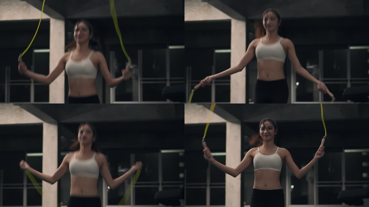 亚洲年轻的女运动员在室内健身房里跳绳，只专注于有氧运动训练。