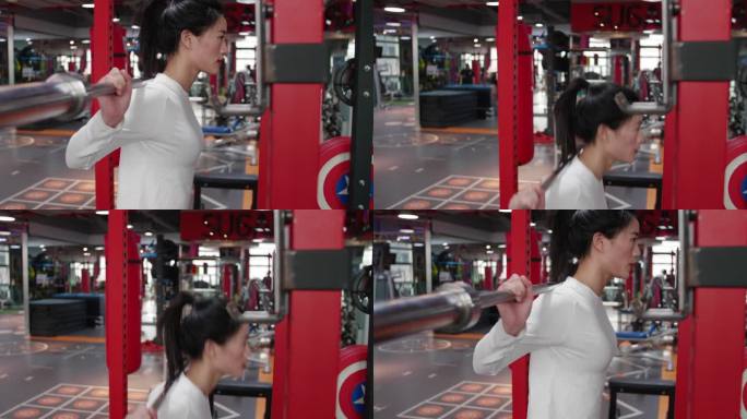 美女健身房撸铁蹲举杠铃练力量肌肉