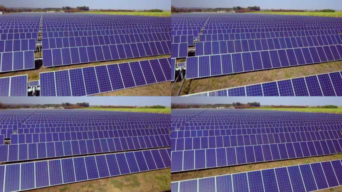 航拍数百个太阳能模块或成行的太阳能电池板，覆盖大片区域，用于清洁能源发电。无人机视角