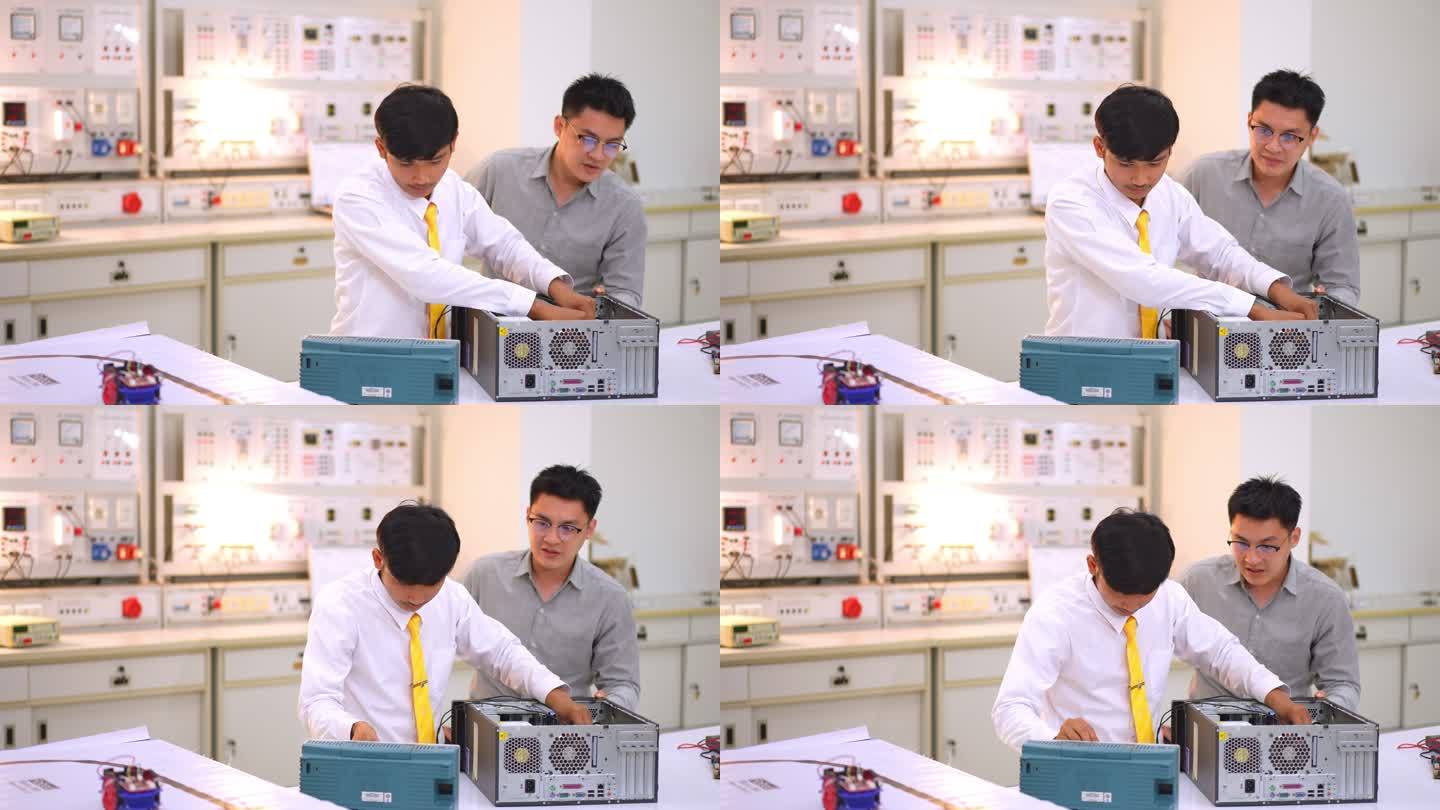 亚洲学生从电子技师老师学习拆卸和固定主板以进行清洁。电脑维修。从板上卸下处理器