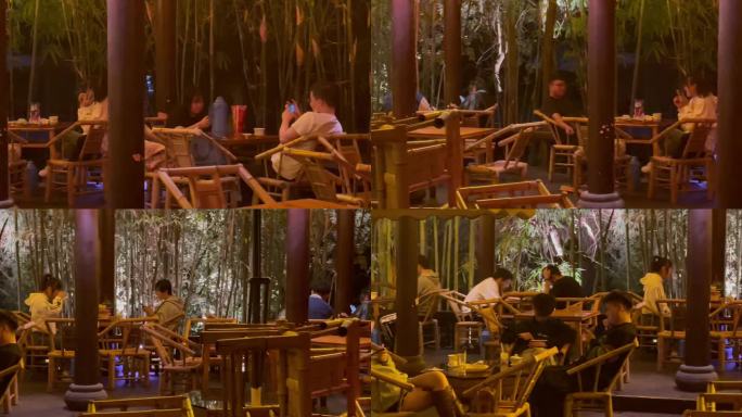 夜晚公园竹编椅喝盖碗茶玩手机的人们