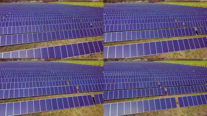 航拍数百个太阳能模块或成行的太阳能电池板，覆盖大片区域，用于清洁能源发电。无人机视角