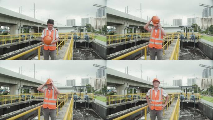 亚洲男工程师身穿反光背心，头戴头盔，检查一家工业厂的污水处理池。戴安全帽的门卫