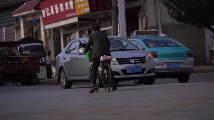 车来车往的街角骑行者