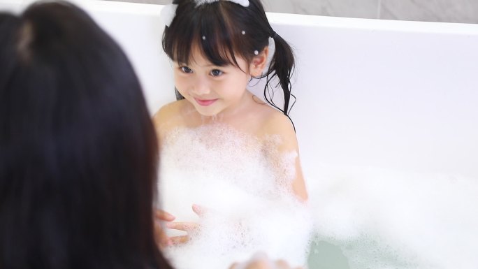 妈妈母亲帮女儿浴缸洗澡玩耍吹泡泡亲子游戏