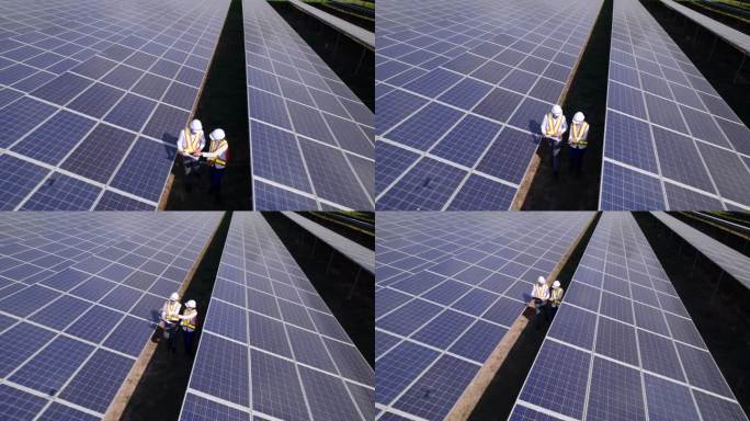鸟瞰太阳能电池技术工程师，检查太阳能农场的太阳能电池板。