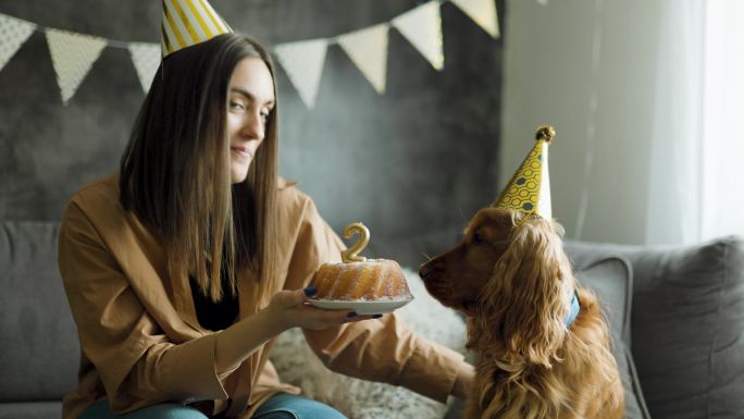女人和狗庆祝狗的二岁生日